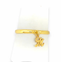 Small script initial M charm dangle ring, personalized custom real gold band on white display, dainty stackable style.