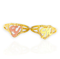 Two gold rings with 'V' and 'M' designs on a white background