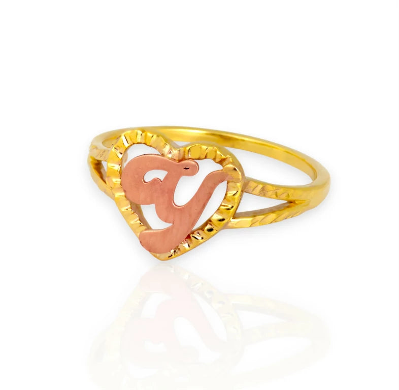 Gold ring with a heart-shaped design on a white background, rose gold initial